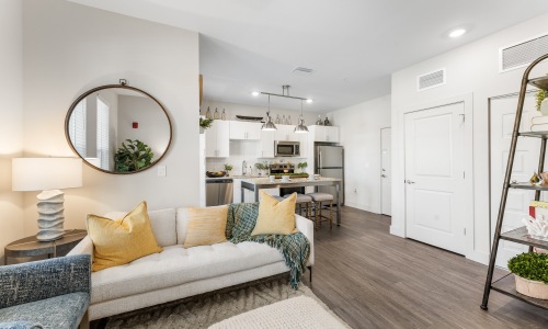 living room with couch mirror and lamp