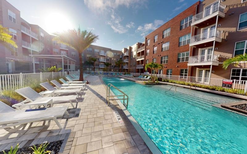 a pool in a courtyard between buildings