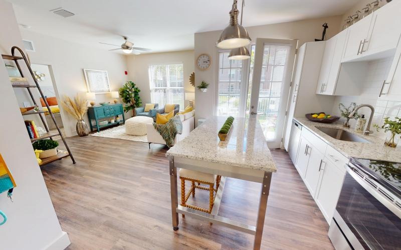 a kitchen with an island and a living room