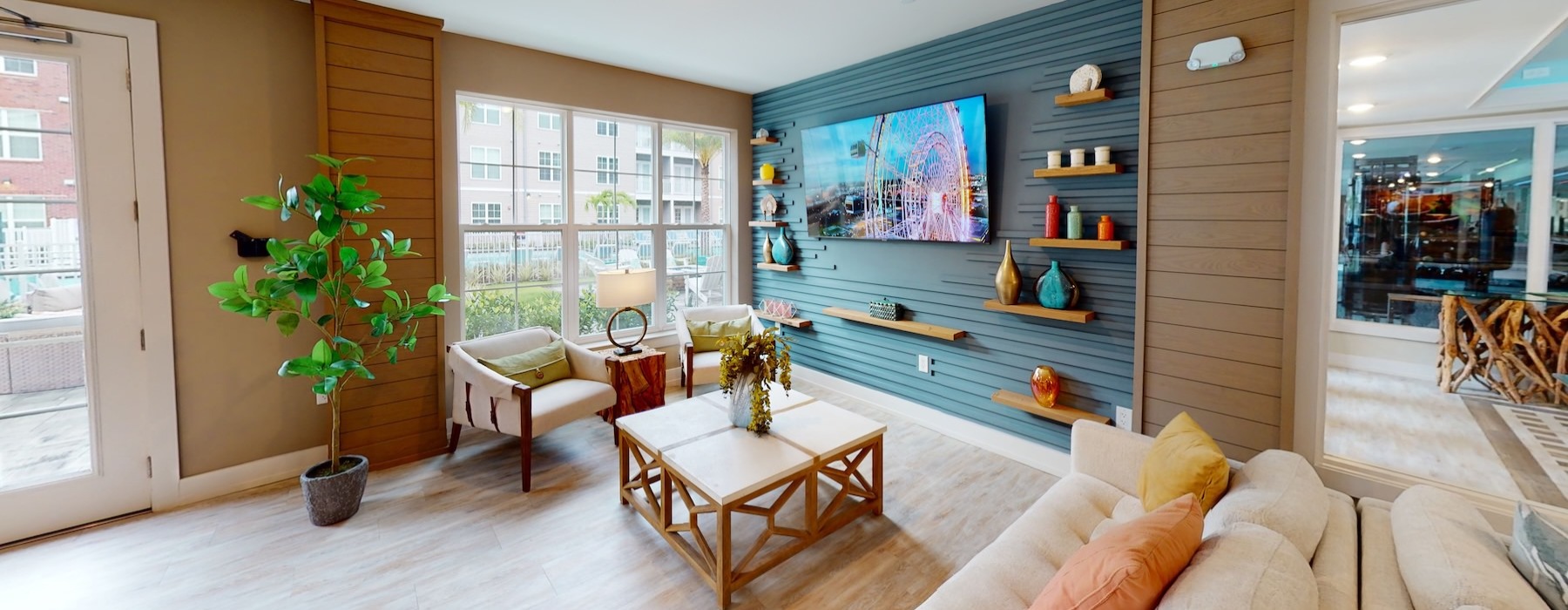 a clubroom with couches, a table and a tv