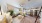 a living room with a couch, chairs and a kitchen
